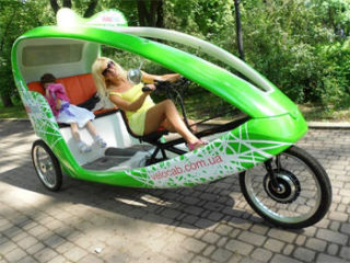 On streets of Kiev appeared new ecological transport | Order electric bicycle taxi by brand VeloTaxi